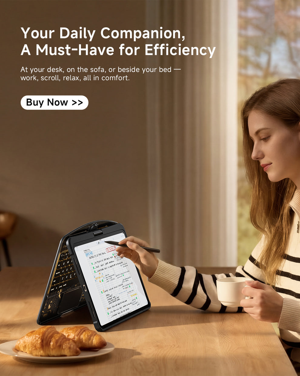 Your Daily Companion – A woman writing on a transparent iPad keyboard case with a pen, enjoying comfort and efficiency while seated with a cup of coffee and pastries in a cozy indoor setting.